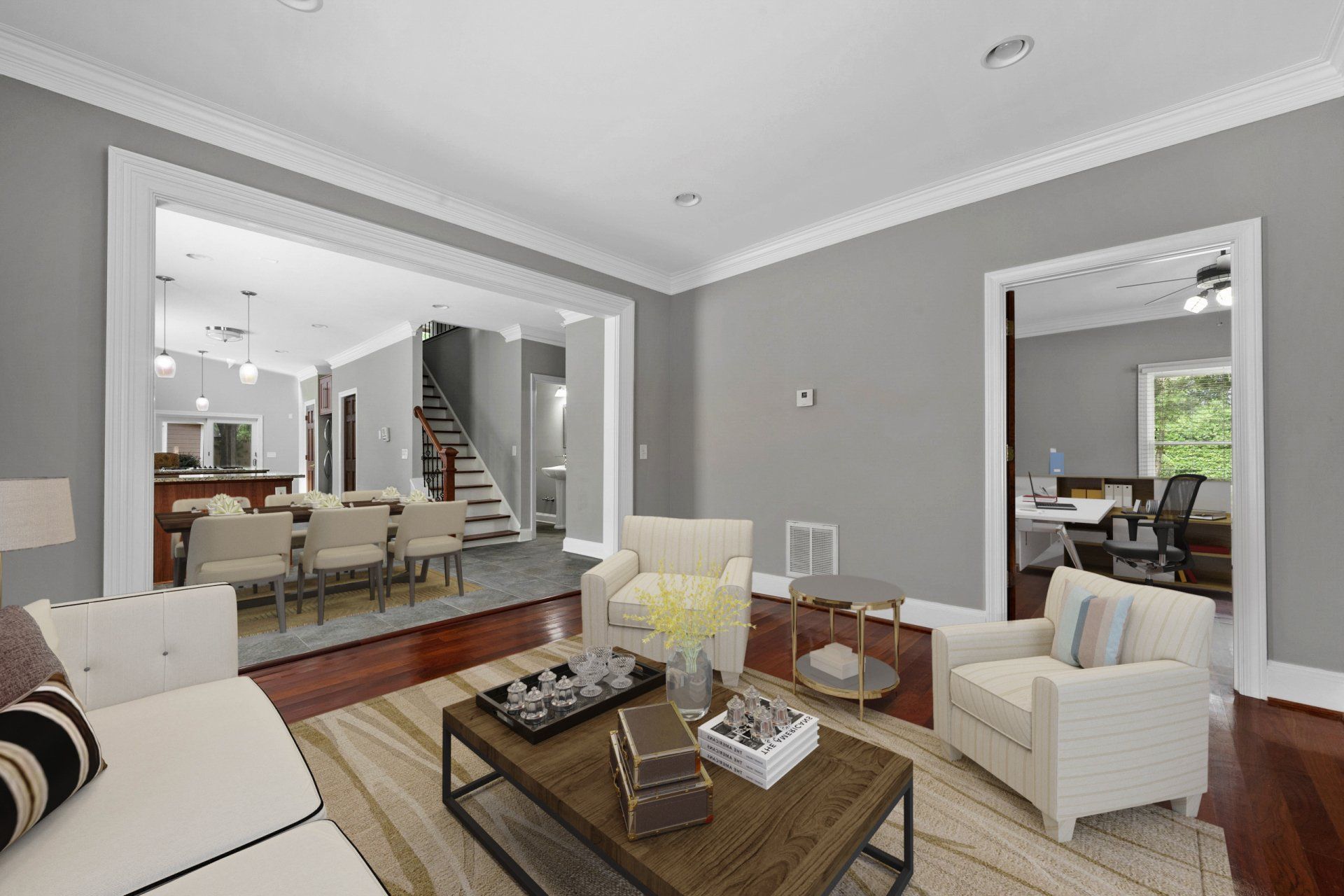 A living room with a couch , chairs , and a coffee table.