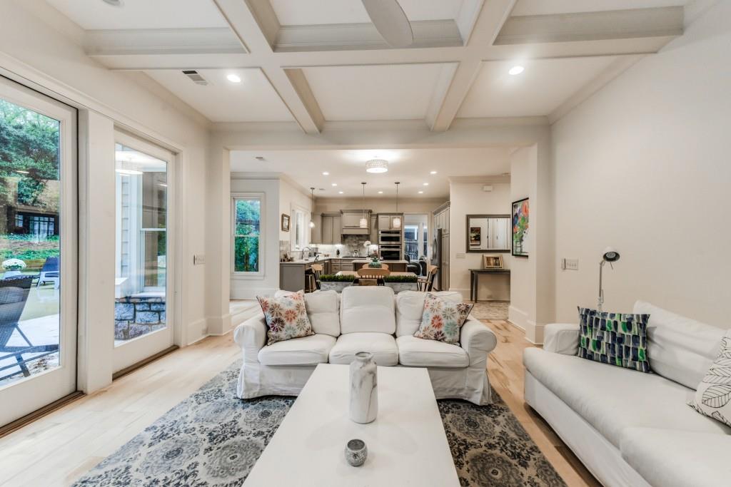 A living room with two couches , a coffee table , and a rug.