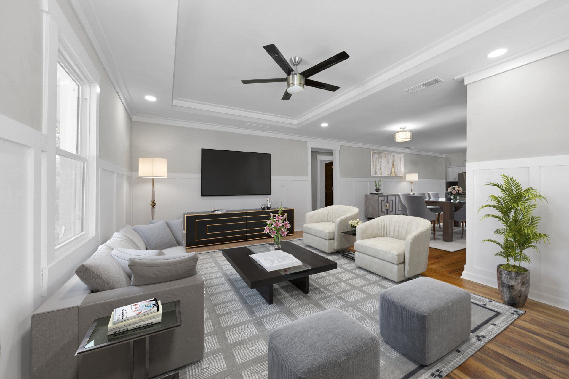 A living room with a ceiling fan and a flat screen tv.