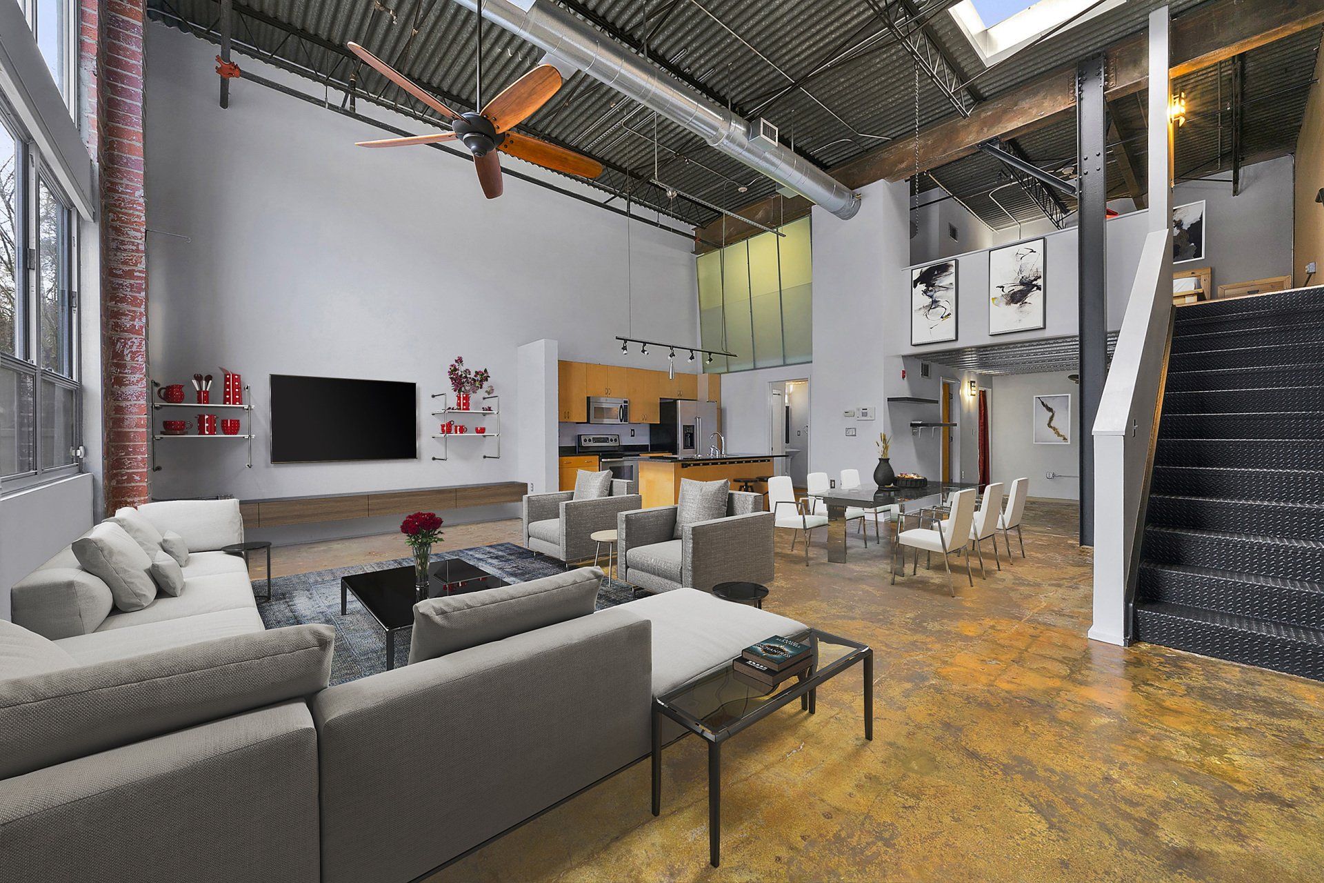 A living room with a lot of furniture and a ceiling fan