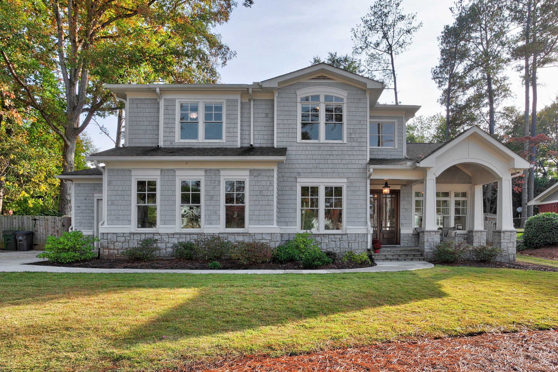 A large house with a lot of windows and a porch