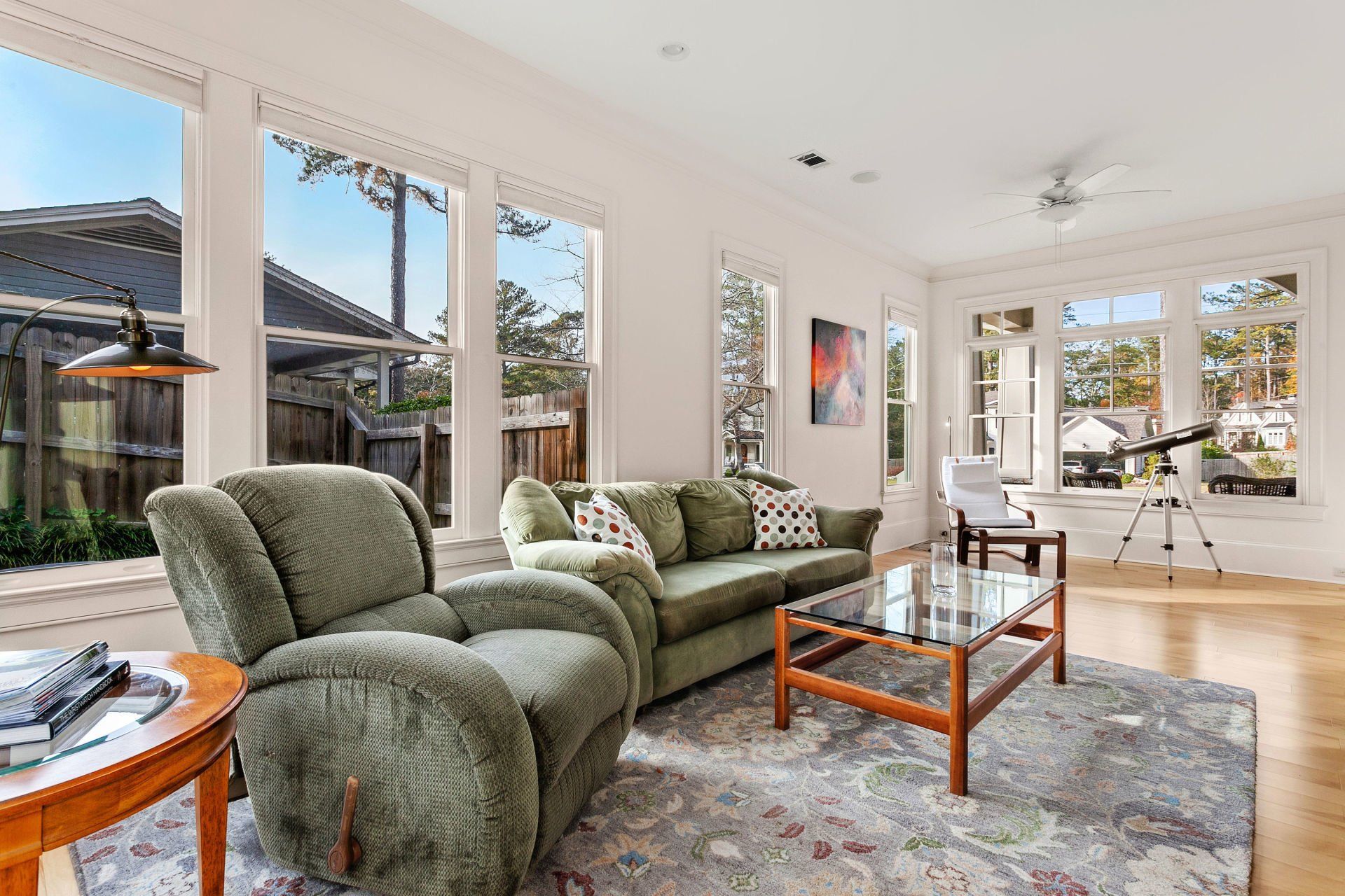 A living room with a couch , chairs , and a coffee table.