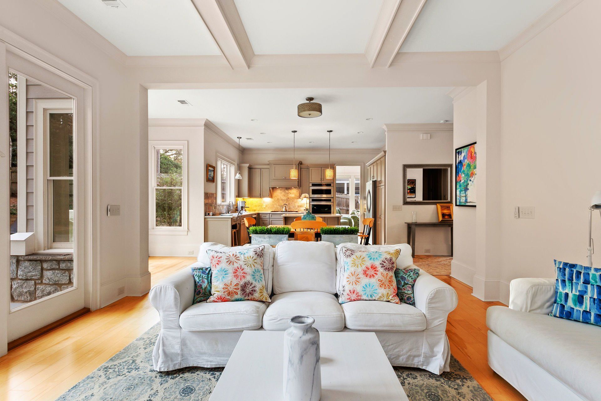 A living room with a white couch and a white coffee table.