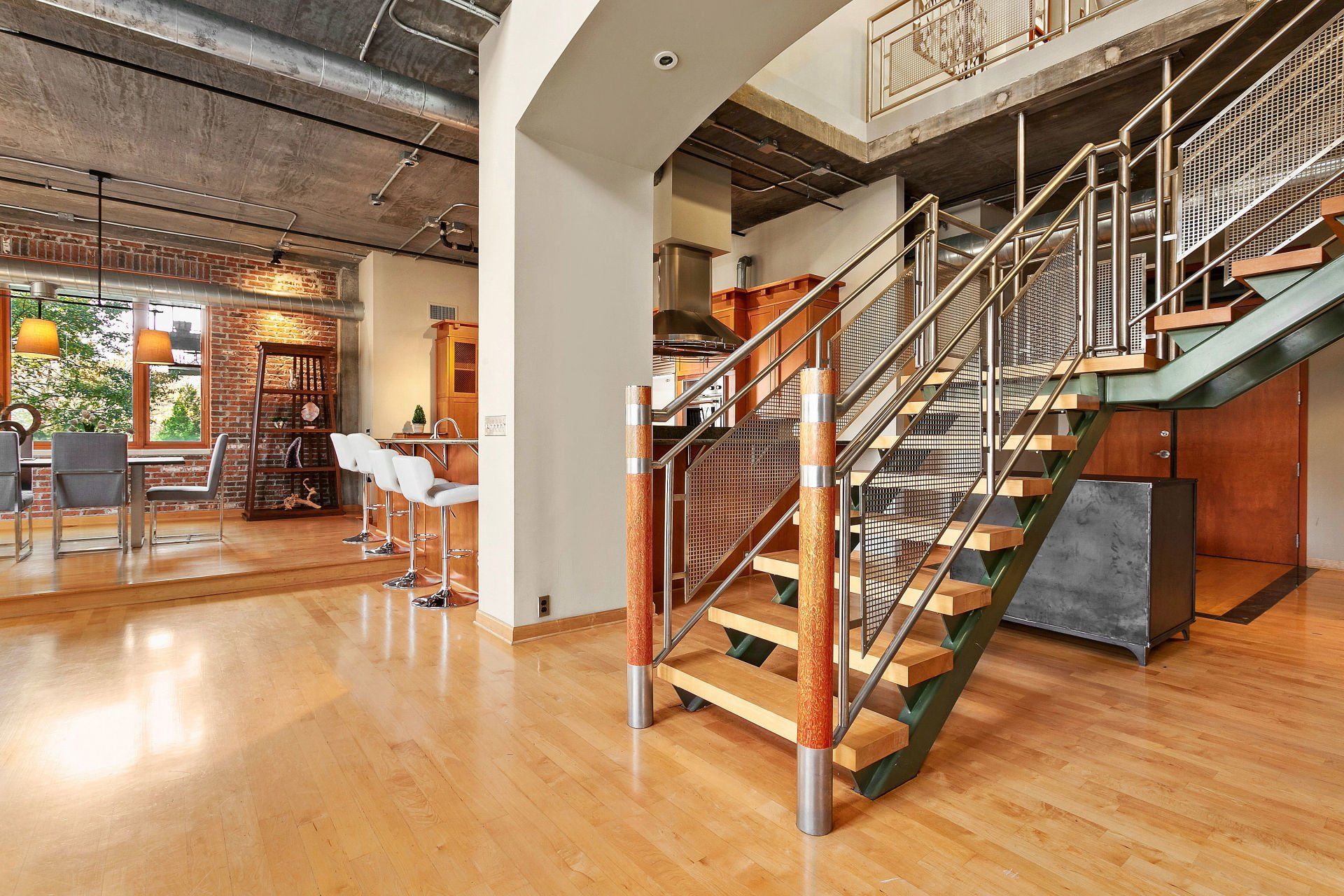 A large room with a staircase leading up to the second floor