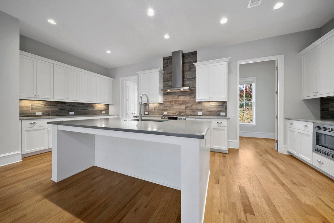 There is a large island in the middle of the kitchen.