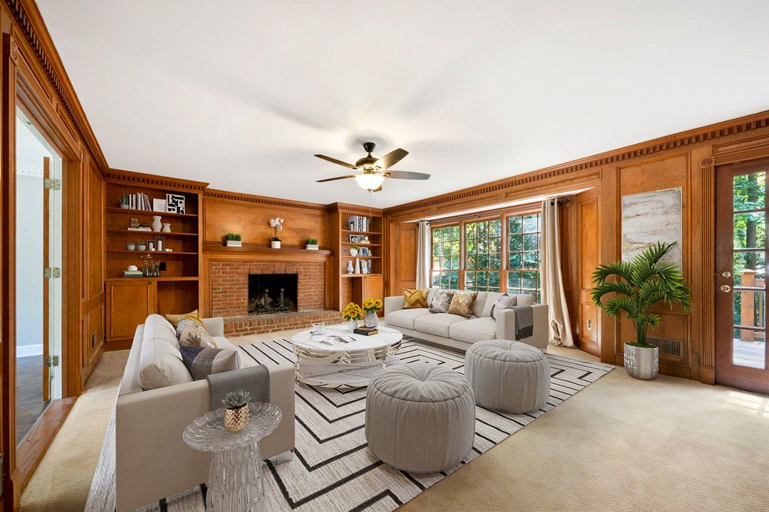 A living room filled with furniture and a fireplace.