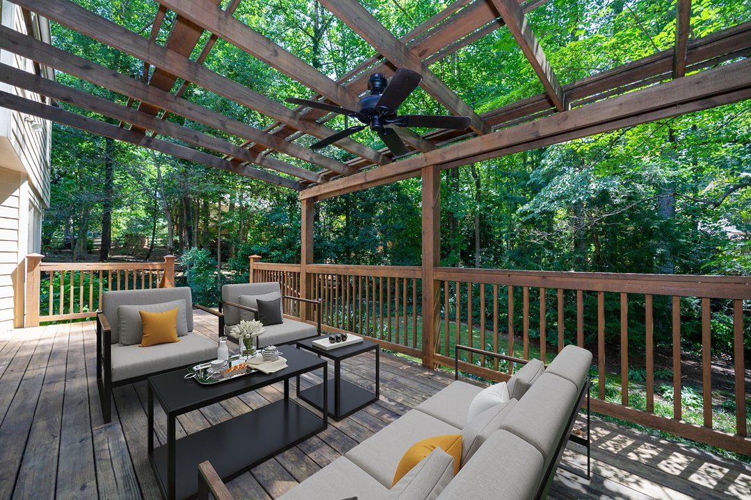 There is a ceiling fan hanging from the ceiling of the deck.