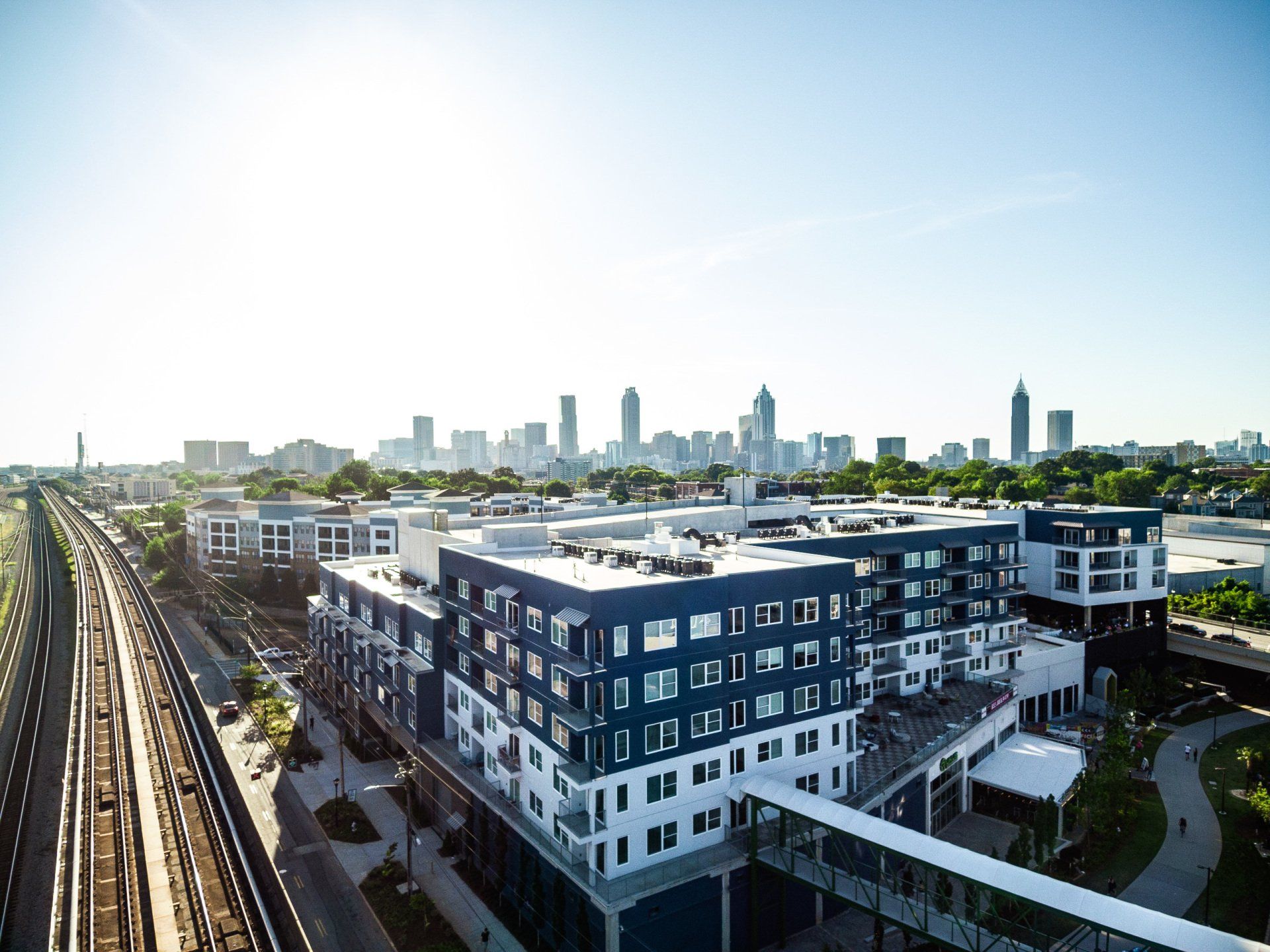 An aerial view of a large building with a city skyline in the background