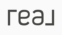 The word real is written in black letters on a white background.