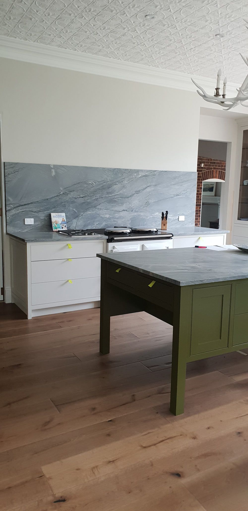Modern Kitchen With Green Island — Styles and Finishes in Balaclava NSW