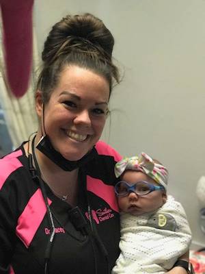 Get lip and tongue tie release from our pediatric dentist in Hammond LA pediatric dentist holding baby | lip and tongue tie release dentist in Hammond LA
