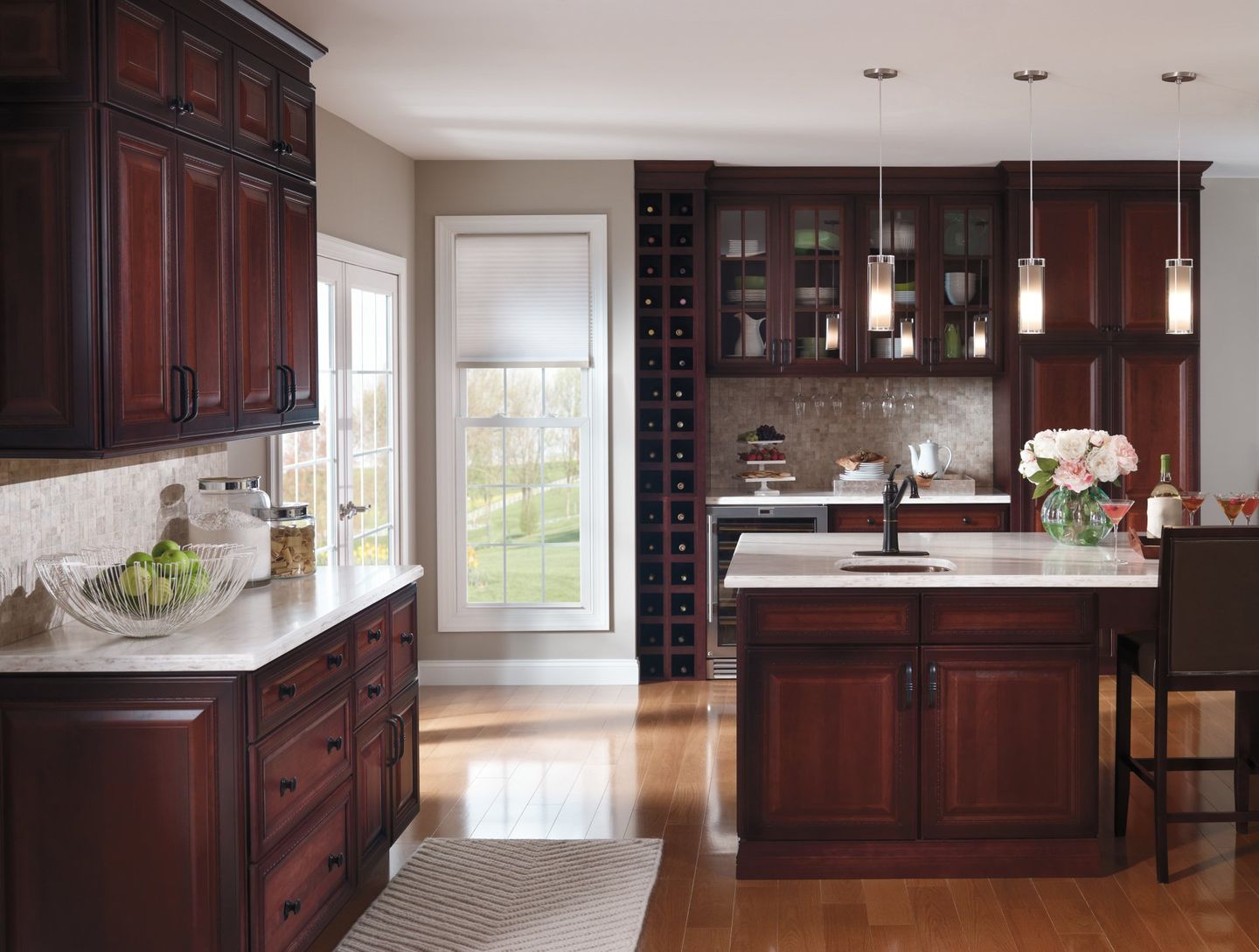Modern kitchen with dark wood cabinets, white countertops, island, and hardwood floors