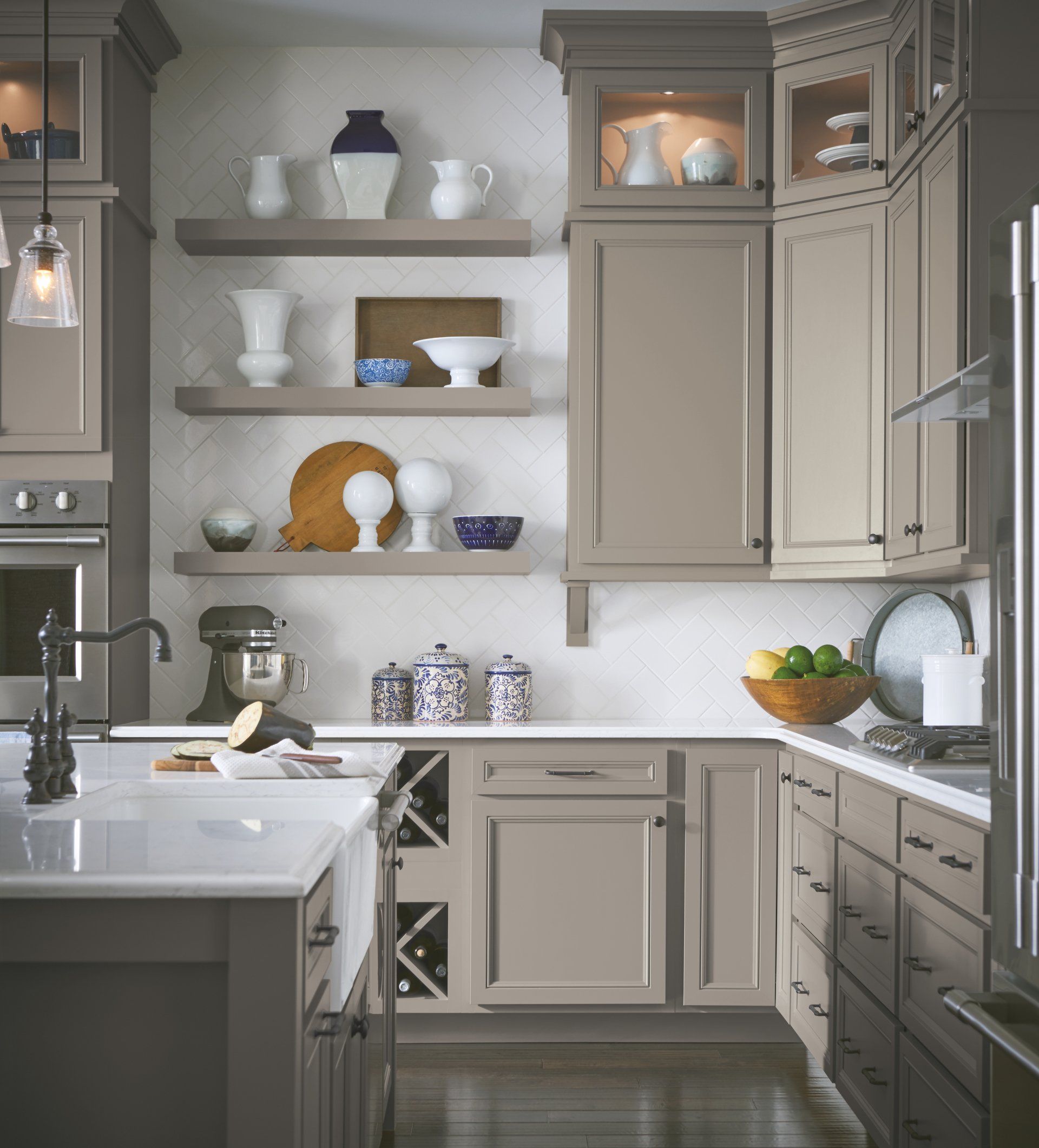Bright modern kitchen with gray cabinets, open shelves, white dishes, and a farmhouse sink.