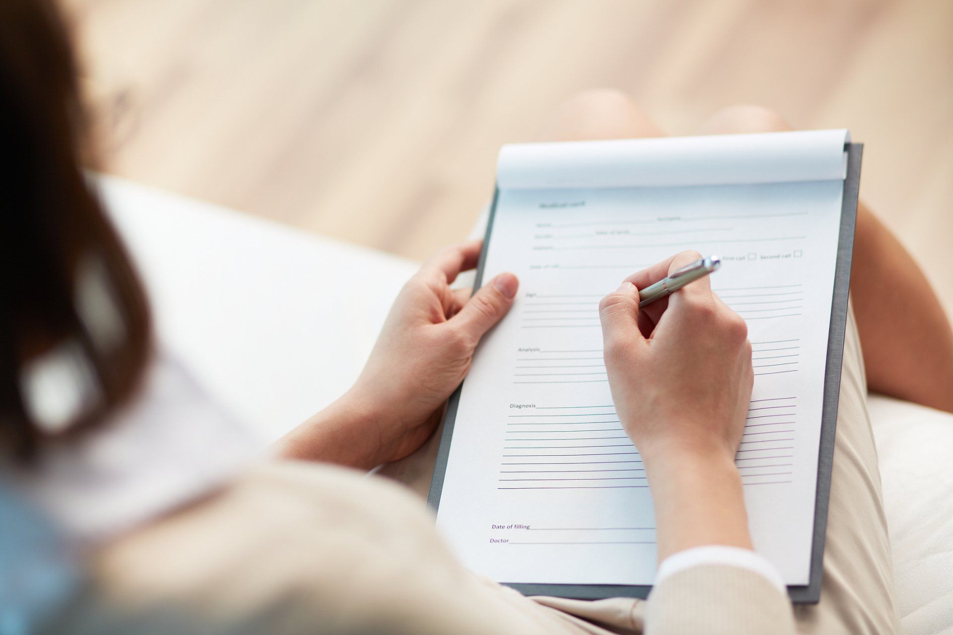 Woman Filling Out Form — Chiropractic Care in Manahawkin, NJ