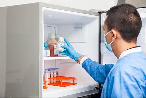 Medical Refrigeration Repair — Doctor Getting Plastic Bottle In Refrigerator in Gresham, OR Medical Refrigeration Repair — Doctor Getting Plastic Bottle In Refrigerator in Gresham, OR