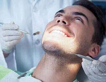 Man having a tooth check up — Oral Hygiene in Naples, FL Man having a tooth check up — Oral Hygiene in Naples, FL