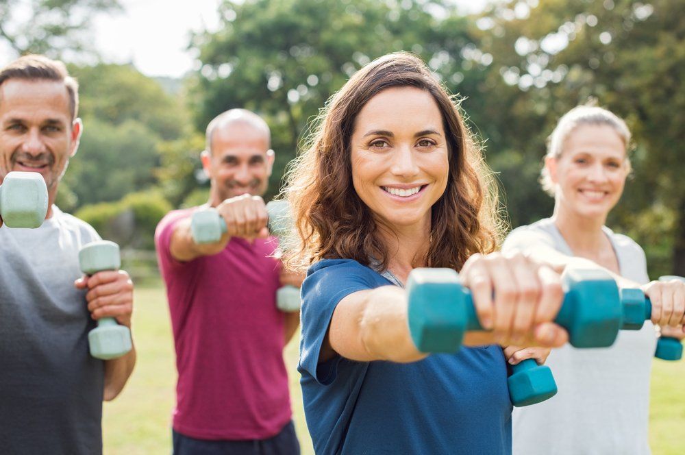 People Using Dumbbells — Greensboro, NC — Merlin Centre For Hypnosis & Enlightenment People Using Dumbbells — Greensboro, NC — Merlin Centre For Hypnosis & Enlightenment