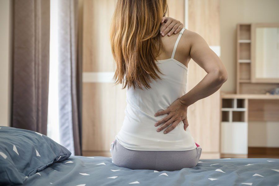 Woman Suffering From Back Ache — Greensboro, N.C — Merlin Centre For Hypnosis & Enlightenment Woman Suffering From Back Ache — Greensboro, N.C — Merlin Centre For Hypnosis & Enlightenment