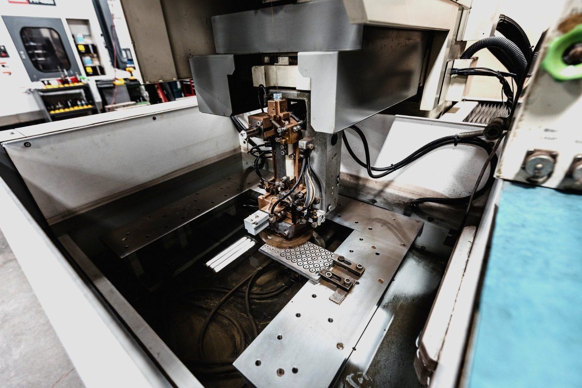 A machine is being used to make a piece of metal