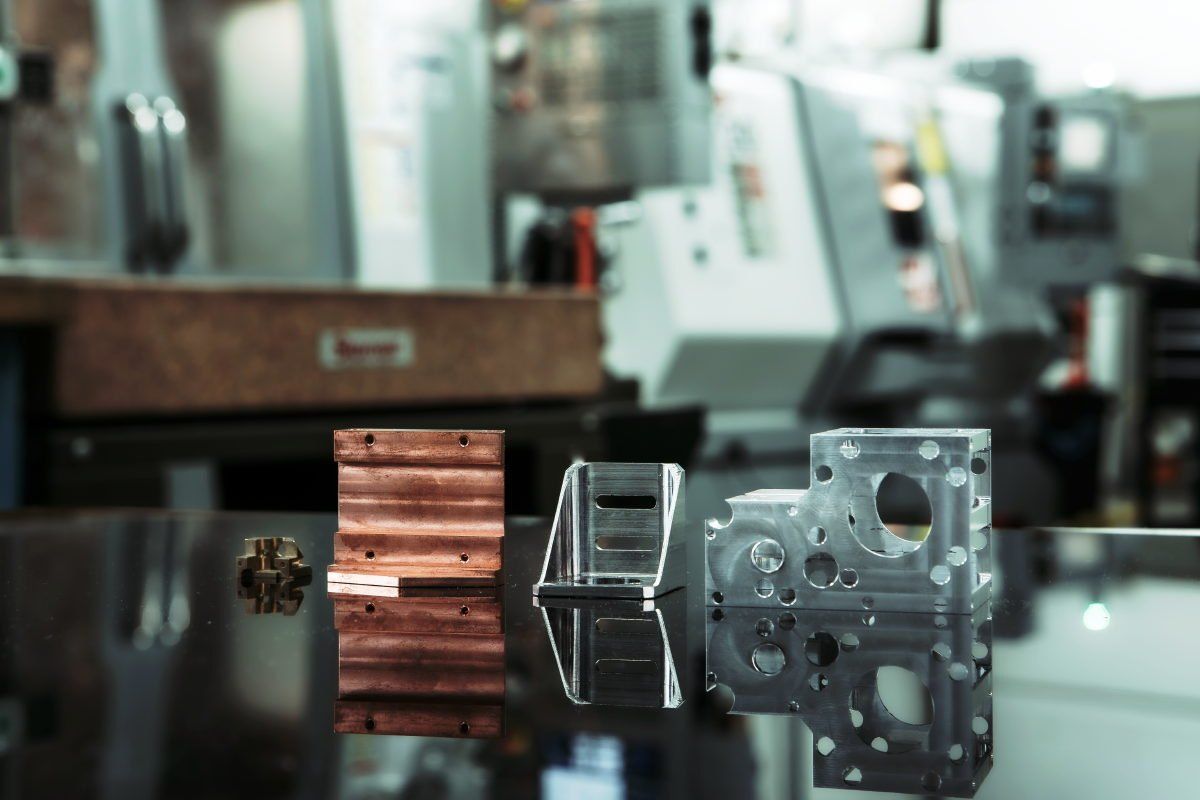 A bunch of metal parts are sitting on a table in a factory.