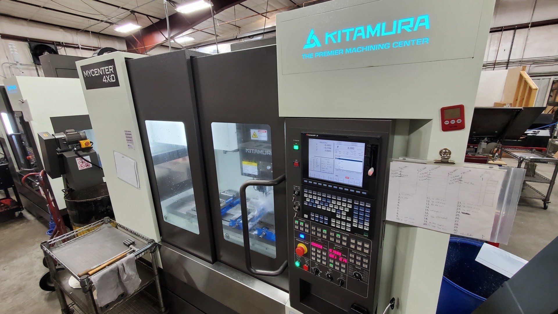 A kitamura machine is sitting in a factory.