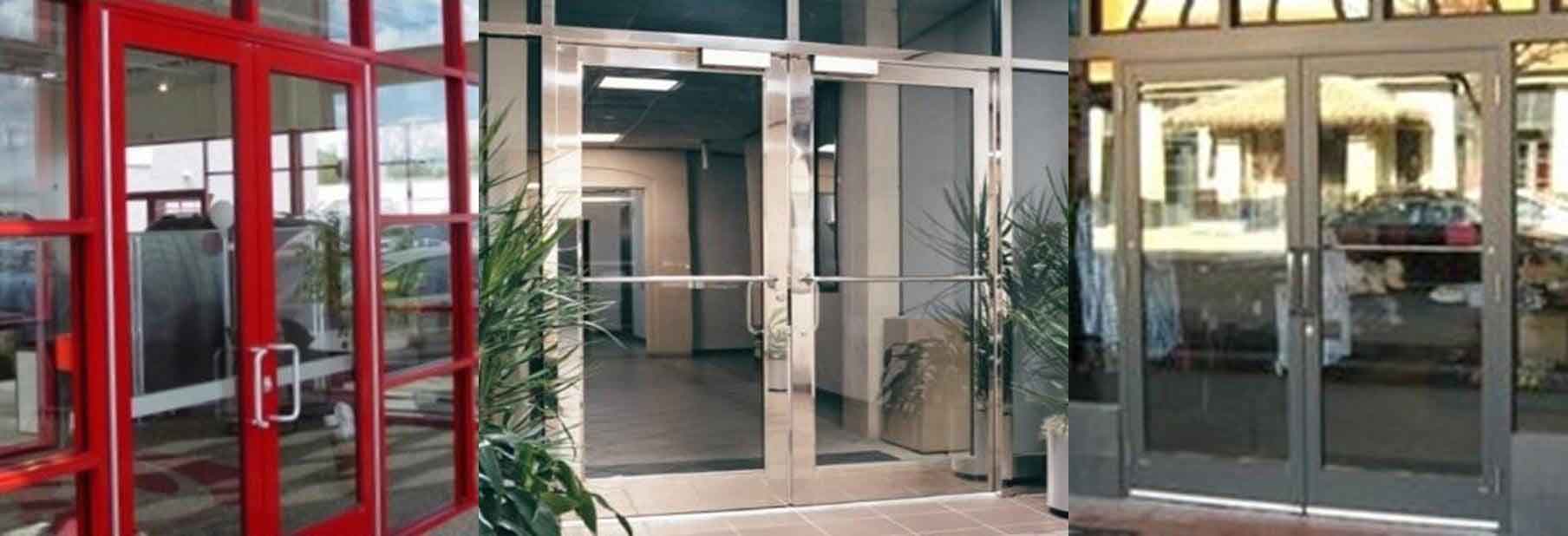 Store Front Door System — Guaranteed Door Service, Inc. Glass office building entrance with red-framed doors and potted plants near the entryway