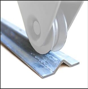 Close-up of a metal cutting wheel trimming a blue corrugated steel sheet