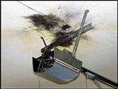 Short Circuit Wiring Repair — Guaranteed Door Service, Inc. Black smoke damage on a ceiling around a mounted smoke detector and metal support bracket