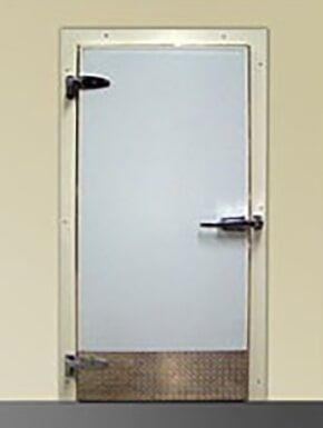 White industrial door with black handle and lower metal kick plate