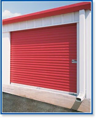 Red roll-up storage door on a white building