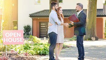 Couple Shaking hands with a lawyer — real estate attorney in Hendersonville, NC Couple Shaking hands with a lawyer — real estate attorney in Hendersonville, NC