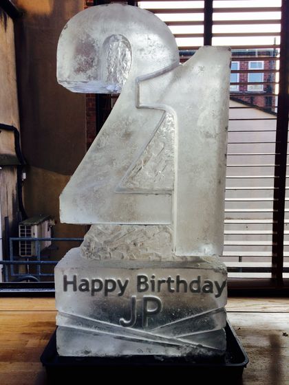 Person drinking from a 21st vodka luge 