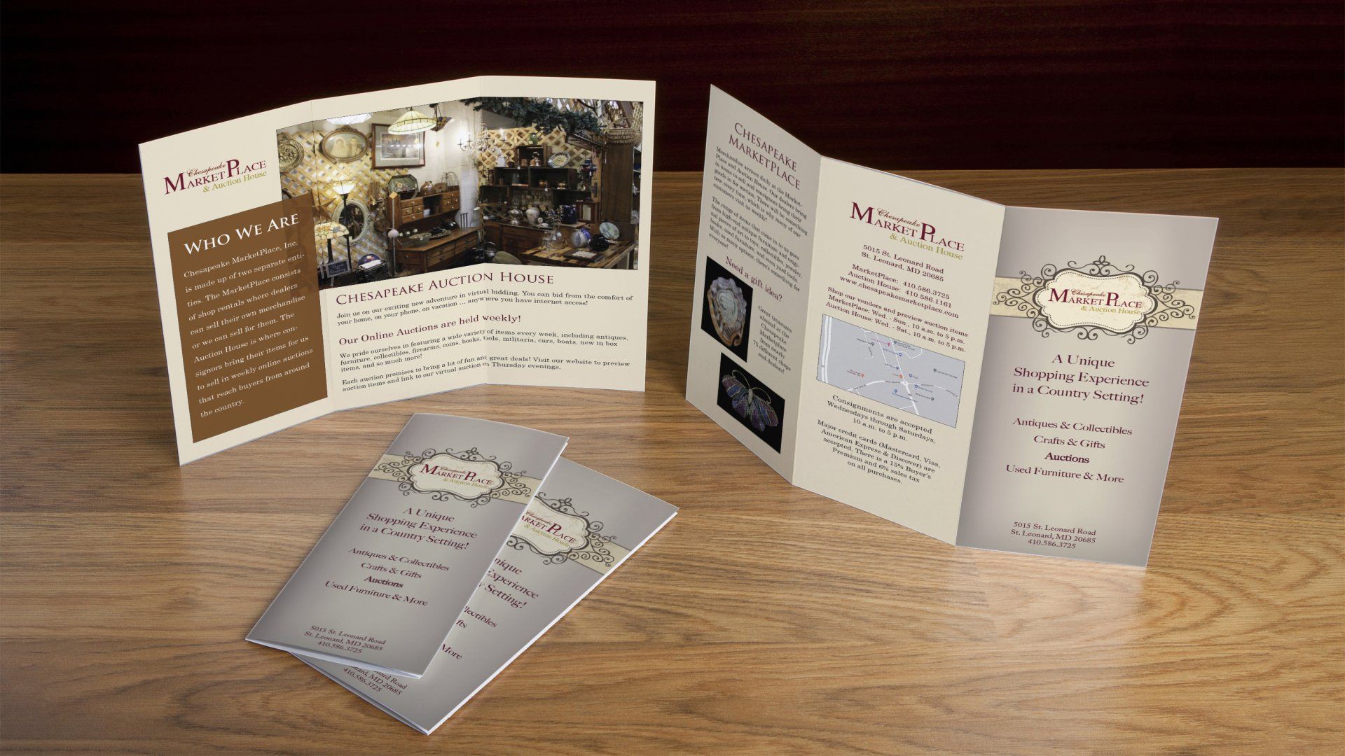 Three brochures are sitting on a wooden table.