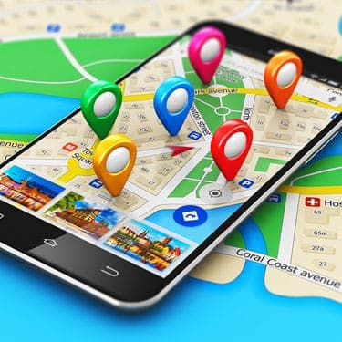 A cell phone displaying a map with markers on it