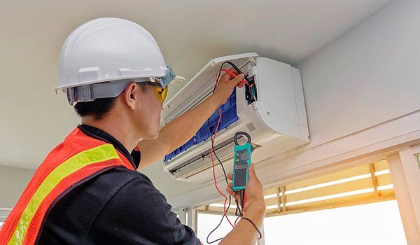 Residential Air Conditioning Installation Lexington Park, MD A technician doing HVAC maintenance in Lusby, MD