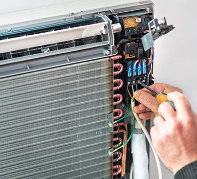 Repairing Air Conditioner — Algonquin, IL — JM Services Heating & Air Conditioning Inc. Repairing Air Conditioner — Algonquin, IL — JM Services Heating & Air Conditioning Inc.