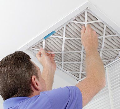 Removing Ceiling Air Filter — Algonquin, IL — JM Services Heating & Air Conditioning Inc. Removing Ceiling Air Filter — Algonquin, IL — JM Services Heating & Air Conditioning Inc.