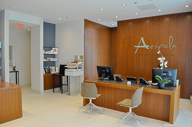 A reception area with a wooden desk and chairs
