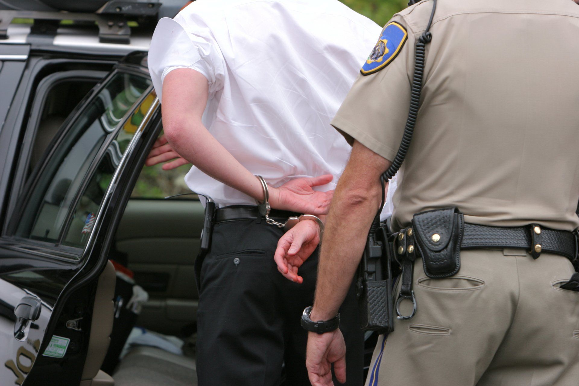Officer Arresting A Man — Newark, NJ — Fast Break Bail Bonds