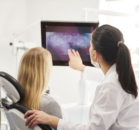 Dentist and Patient Looking at X-Ray Image — Fort Myers, FL — Children & Adult Dentistry Dentist and Patient Looking at X-Ray Image — Fort Myers, FL — Children & Adult Dentistry