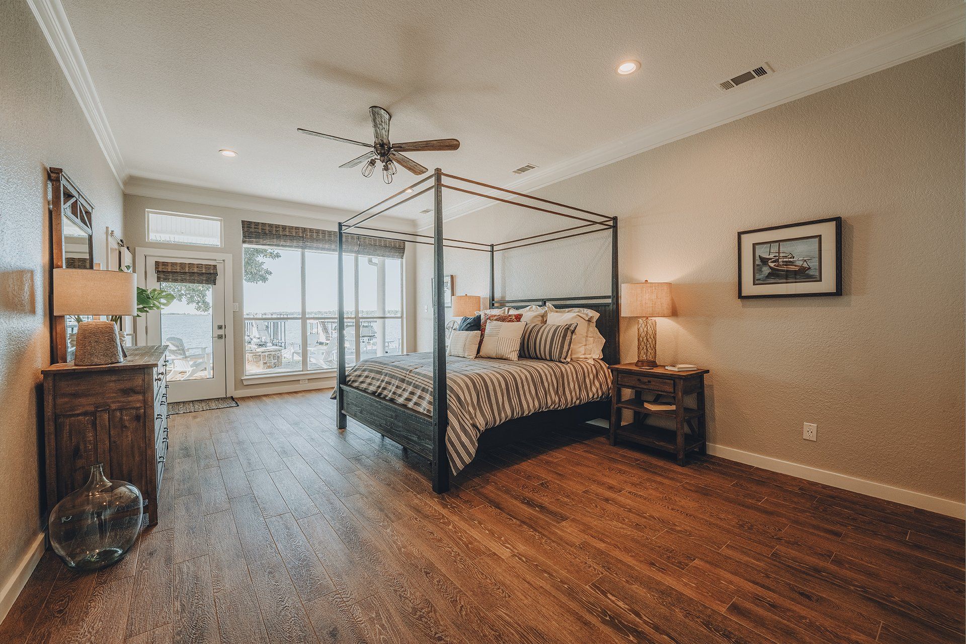 A bedroom with a canopy bed and a ceiling fan.