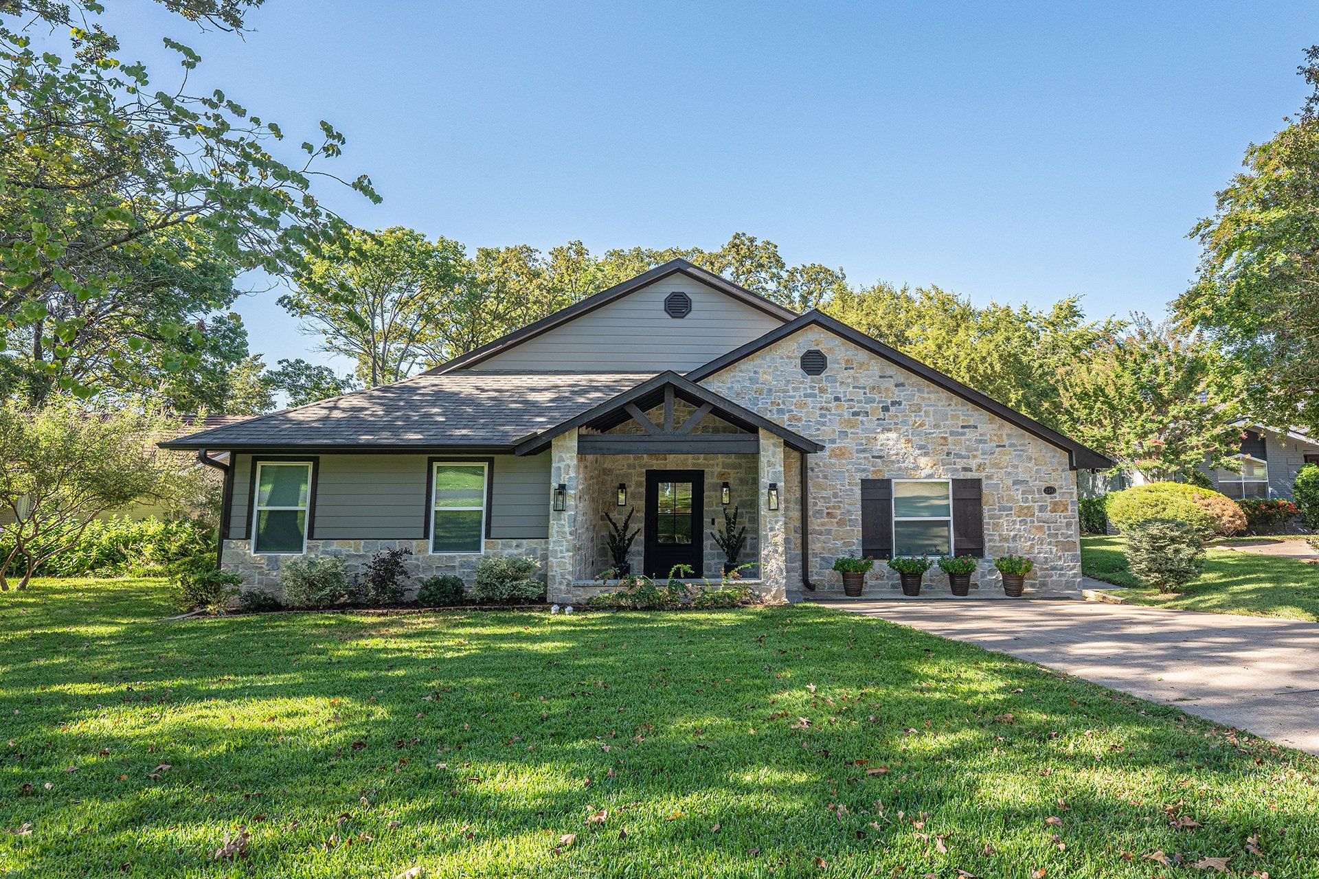 A house with a large lawn in front of it is for sale.