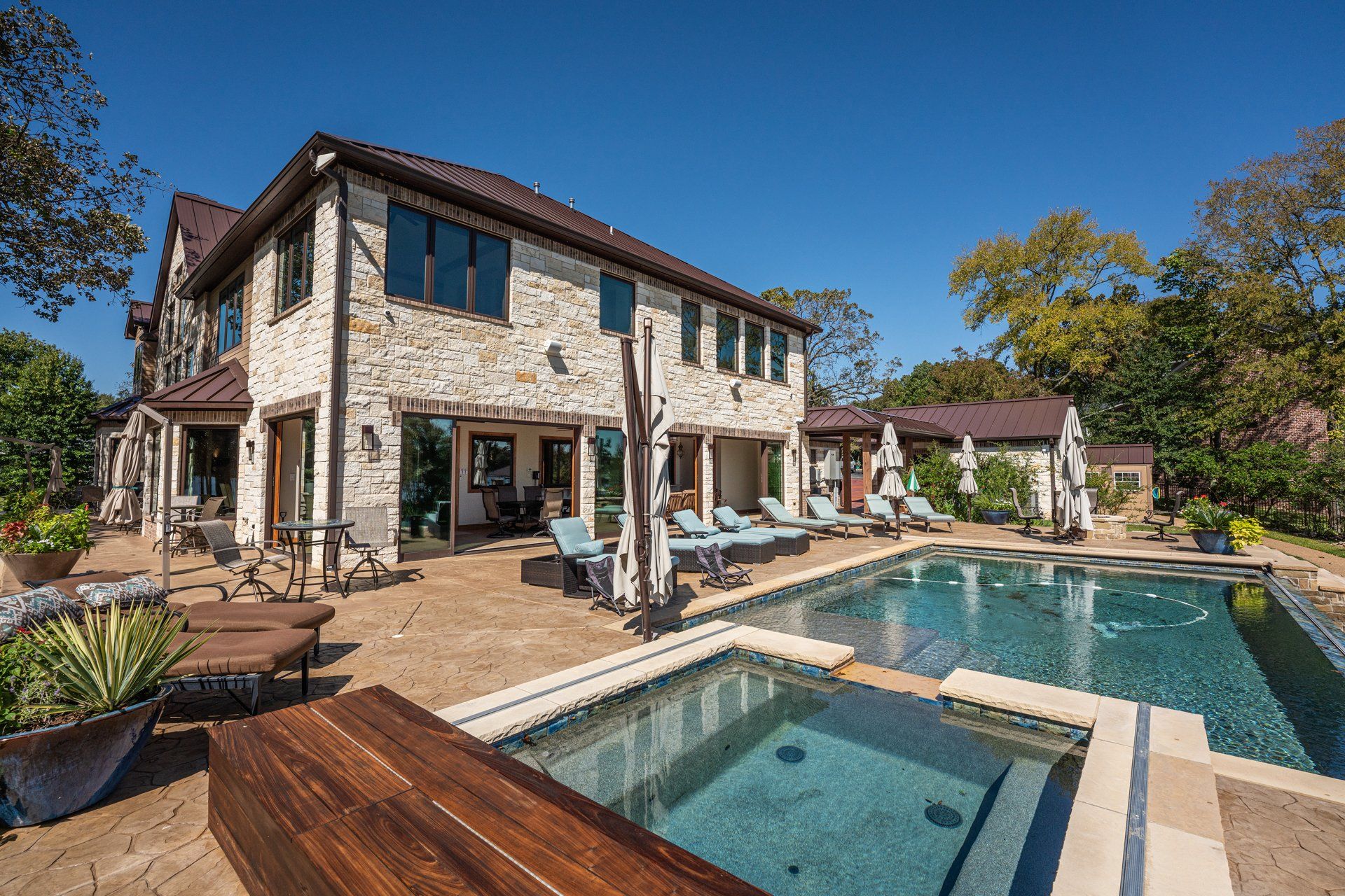 A large house with a large swimming pool in front of it.