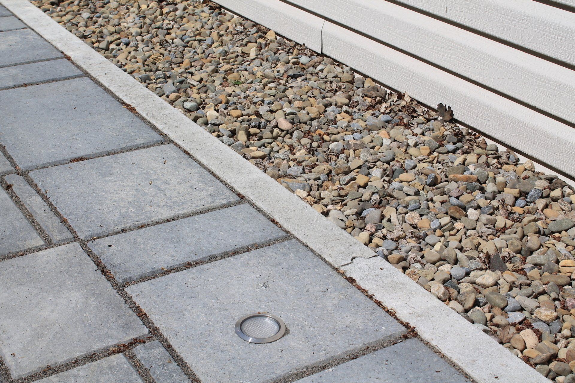 grey unistone with rocks next to it