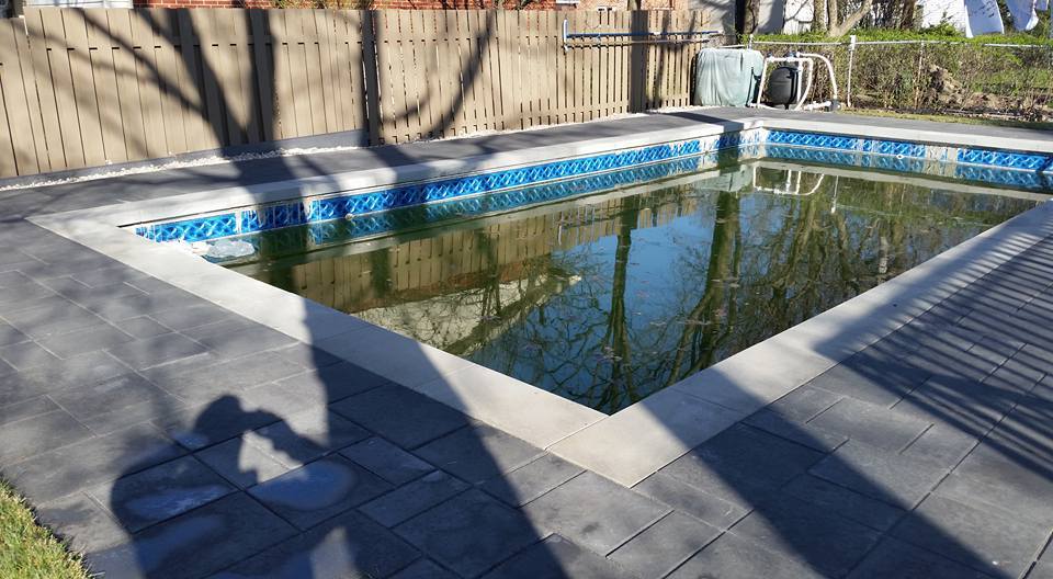 backyard with pool surrounded with unistone