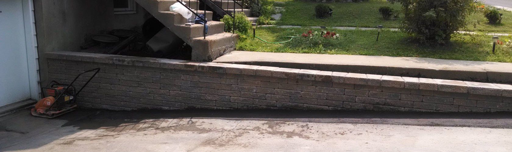 descending driveway with unistone wall