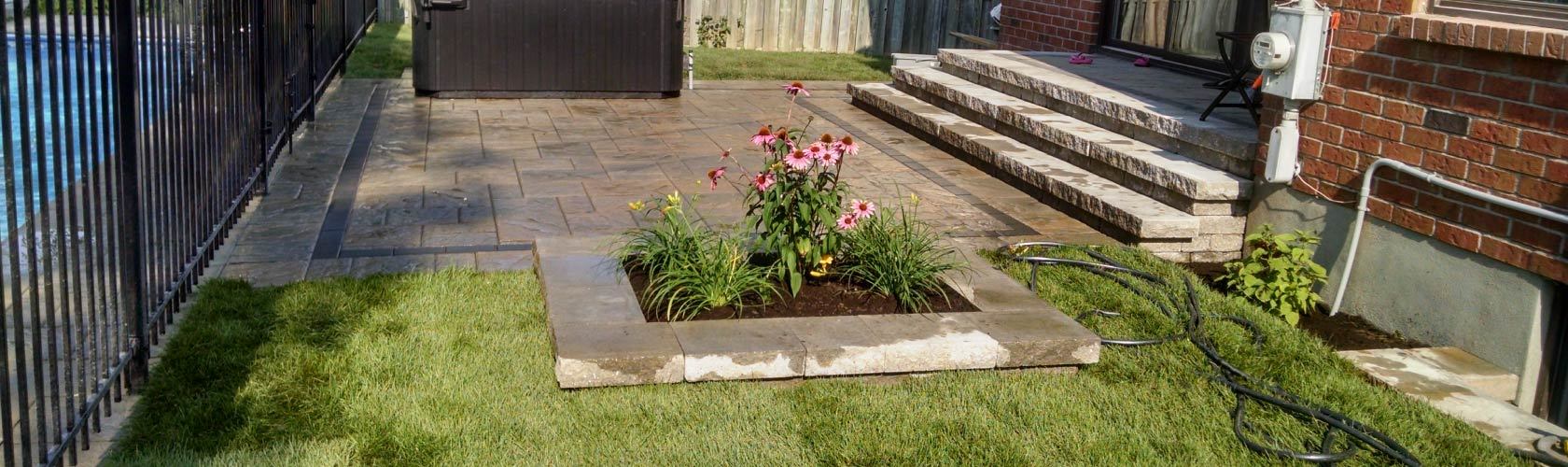 backyard with flower bed and green grass