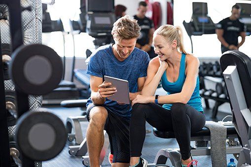 Personal Trainer — Trainer with Woman on Gym in Woburn, MA Personal Trainer — Trainer with Woman on Gym in Woburn, MA