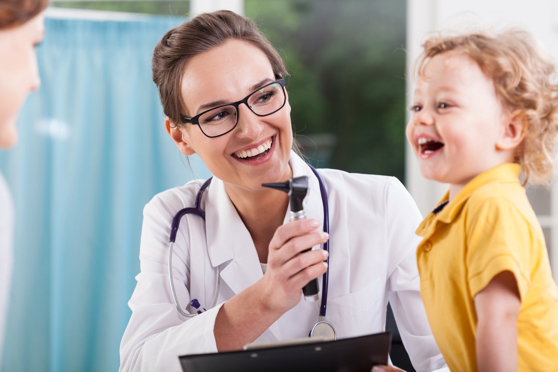 Doctor with laughing child patient