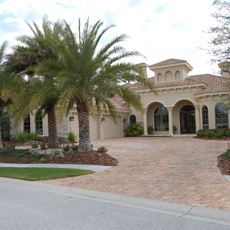A large house with palm trees in front of it